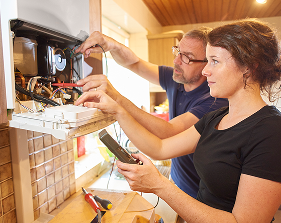 someone being trained how to maintain and repair a gas boiler to be part of the Gas Safe Register