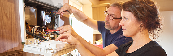 someone being trained how to maintain and repair a gas boiler to be part of the Gas Safe Register