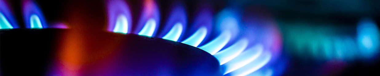 A gas hob burner showing gas flames.