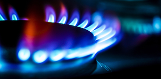 A gas hob burner showing gas flames.