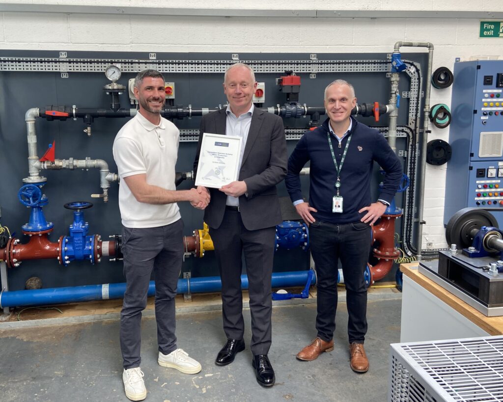 Matthew Heaton, Phil Beach, Grant Batty holding a certificate for the Competent Operator Scheme inside the United Utilities training facility