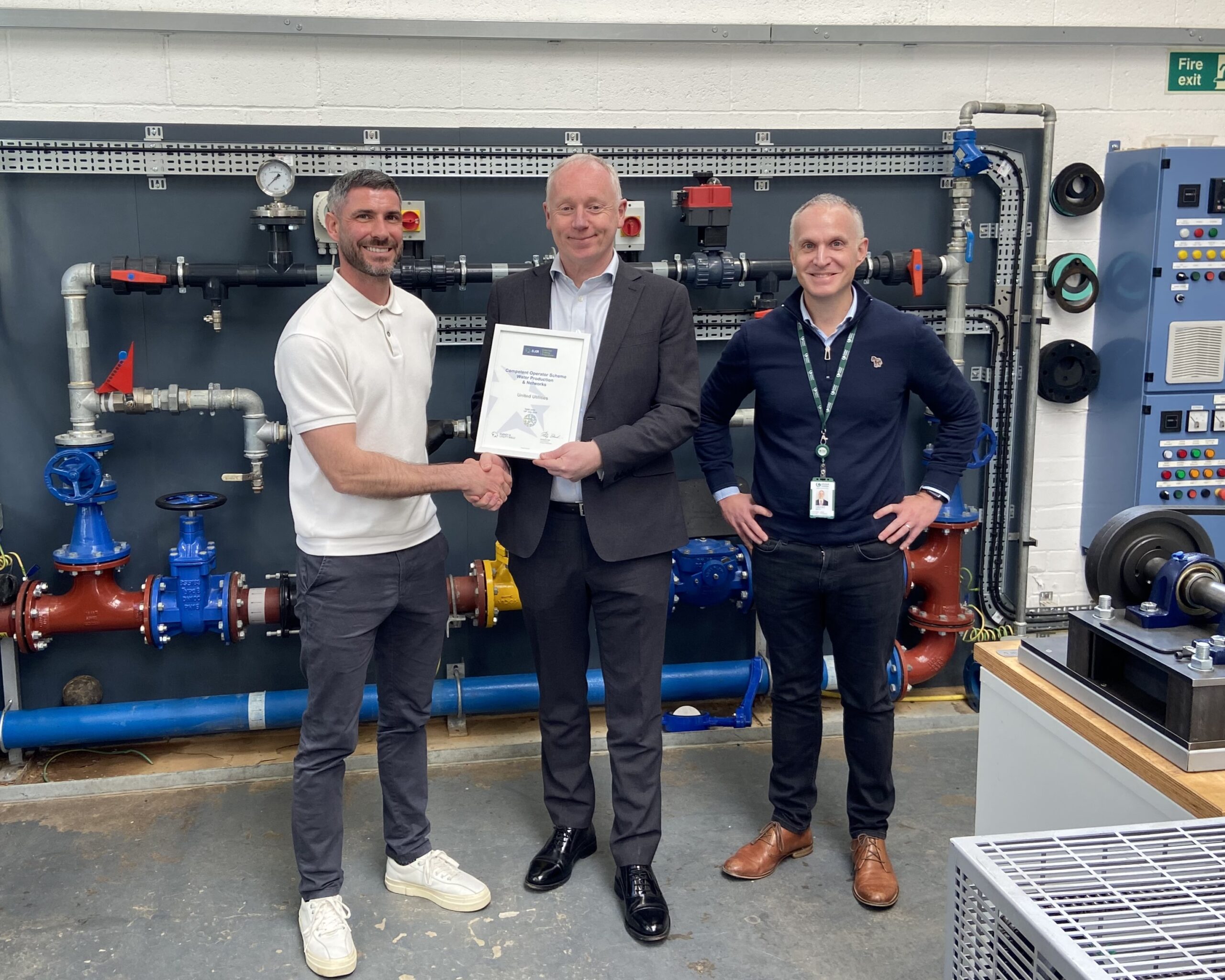 Matthew Heaton, Phil Beach, Grant Batty holding a certificate for the Competent Operator Scheme inside the United Utilities training facility