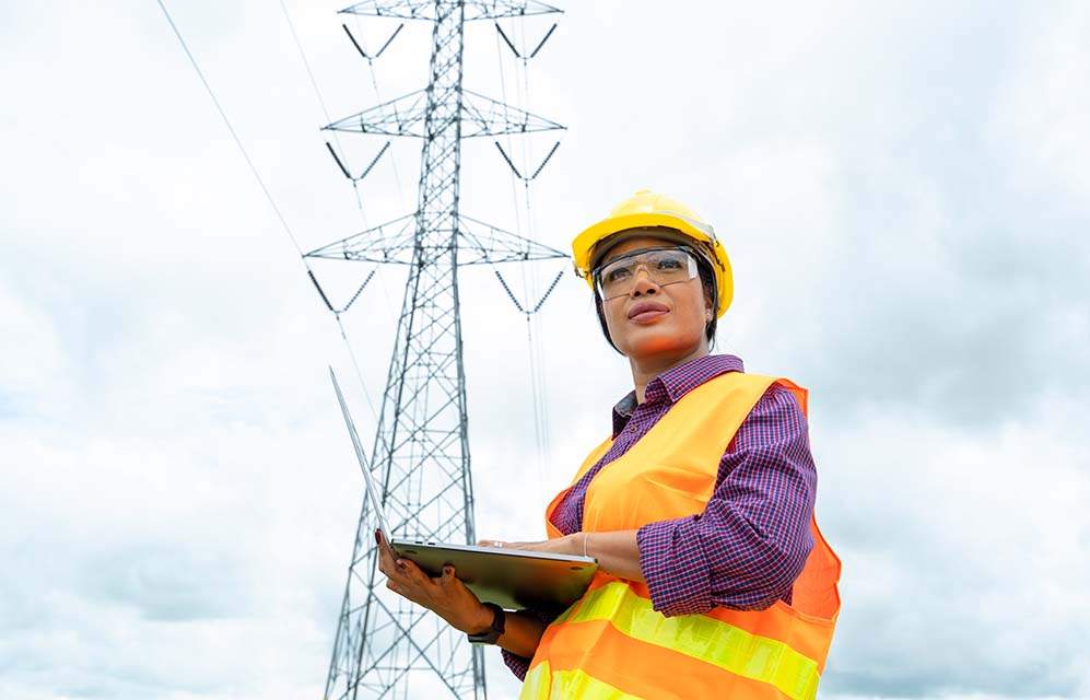 Electrical engineer women use laptop working and checking the power grids.