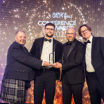 Colleagues from EDF Energy, Bridgwater and Taunton College, Yeovilton Fleet Air Arm Museum accepting their award on stage with comedian, Ed Byrne.