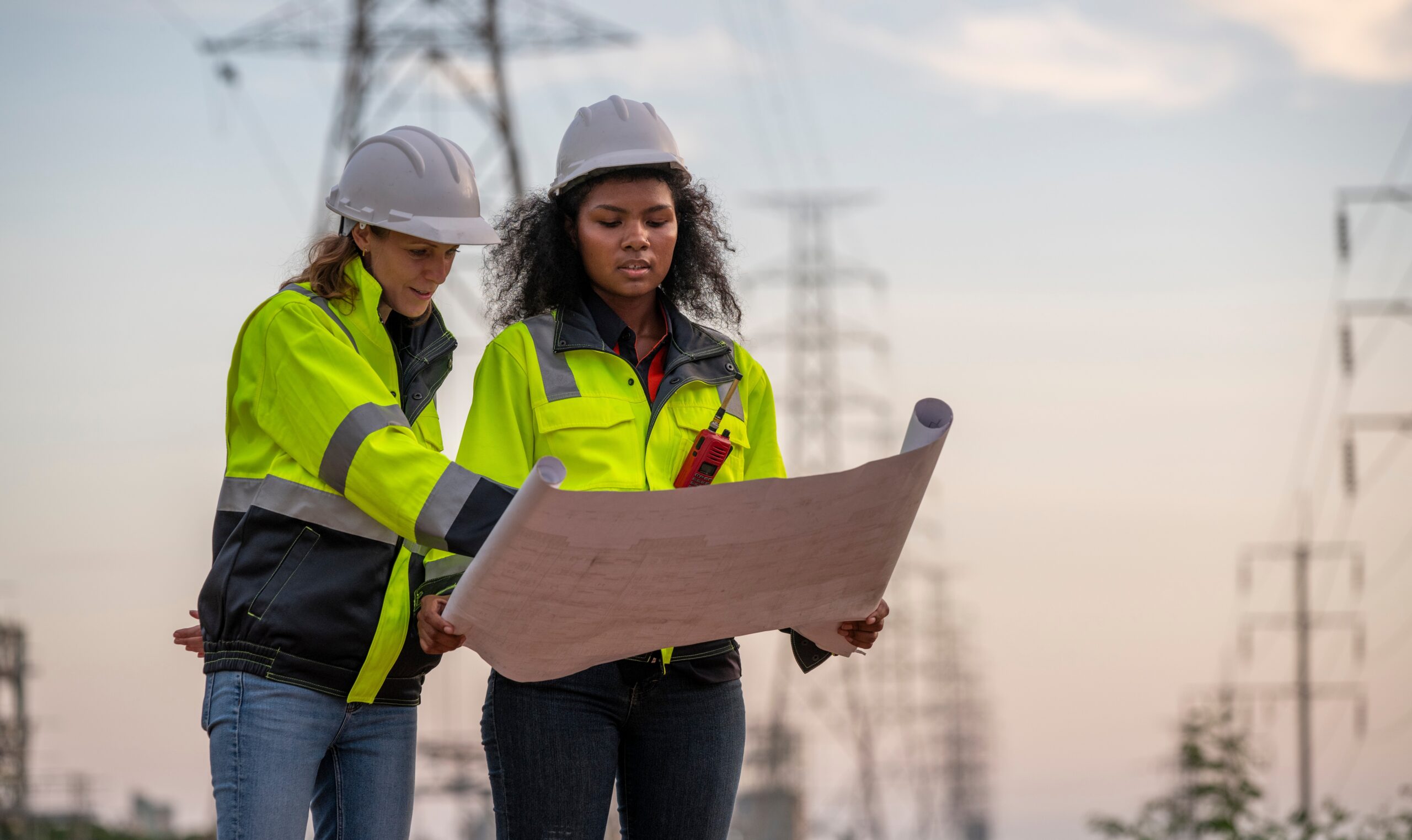 Reading plans by a pylon